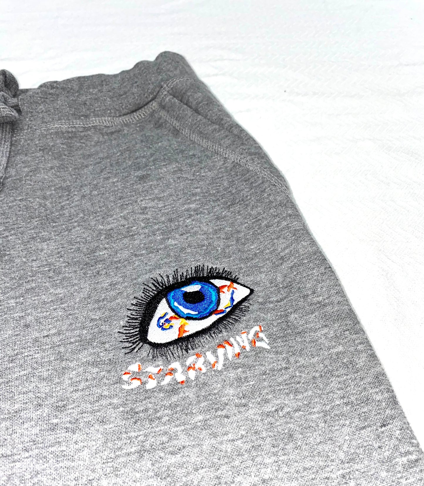 "Fisheye" embroidered fleece sweats